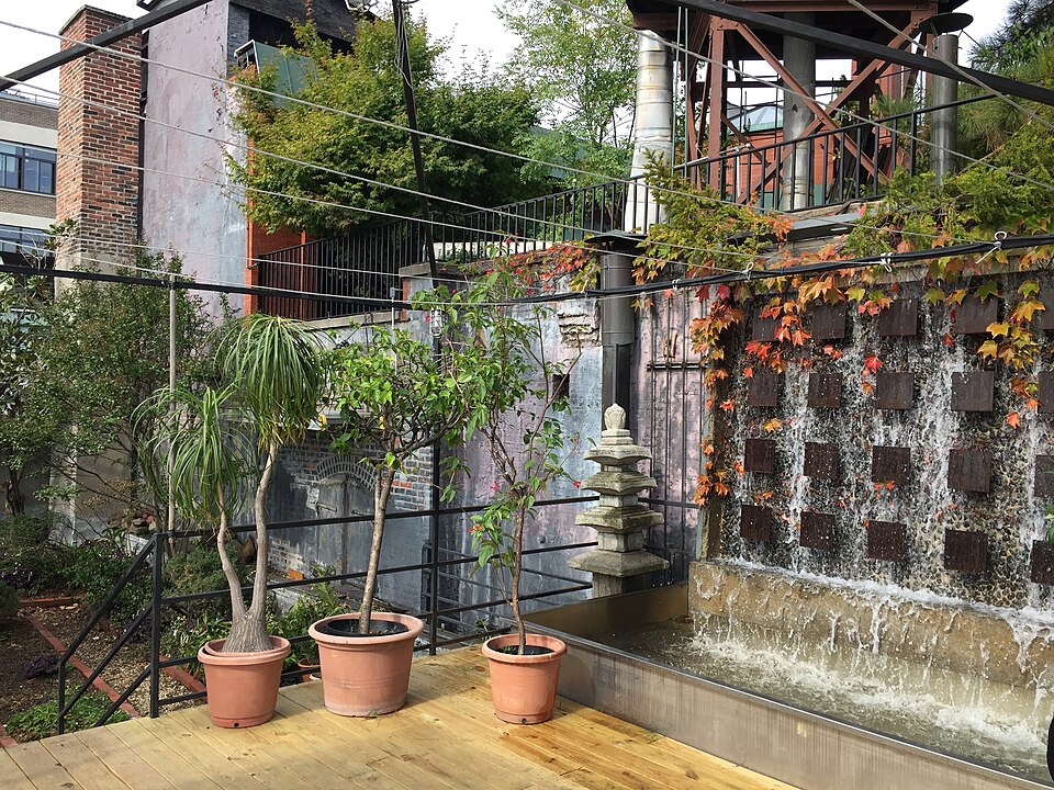 Tank with mini sculpture and waterfall